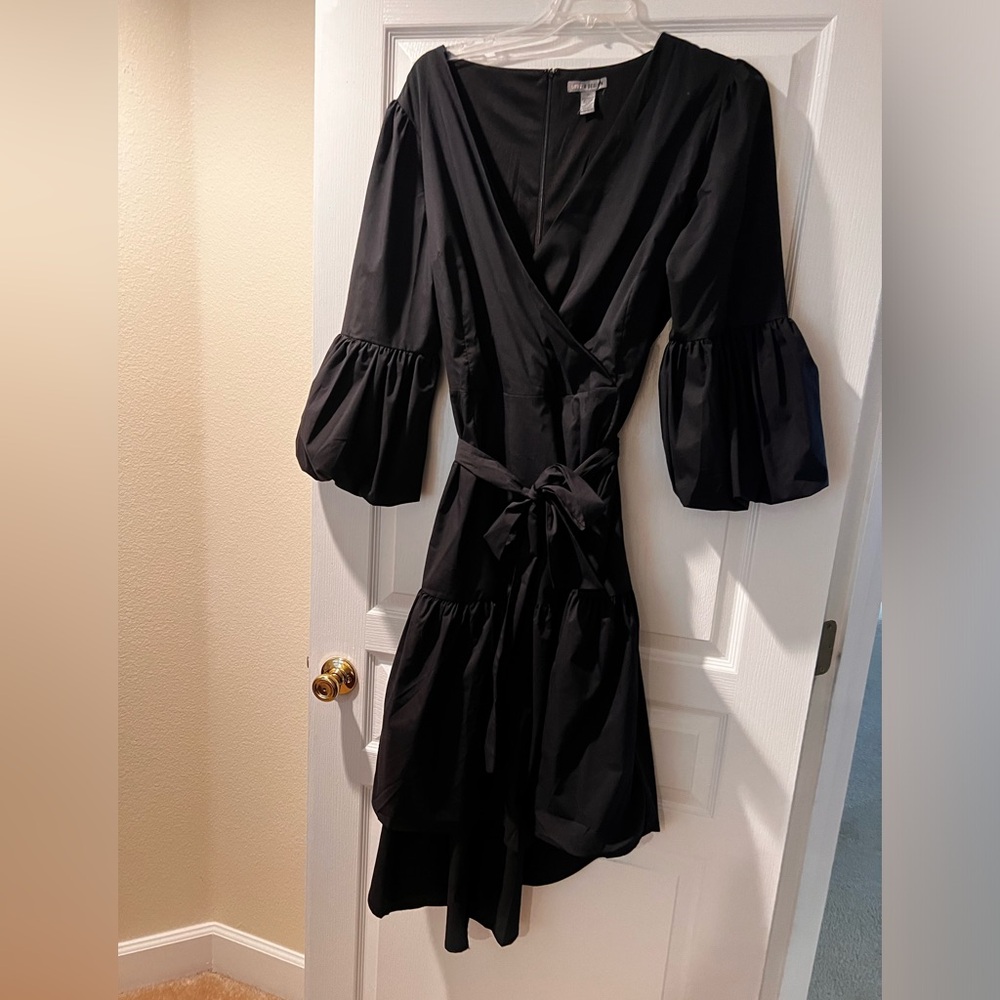 A trendy faux-wrap dress shows off puffed balloon sleeves, high-low.